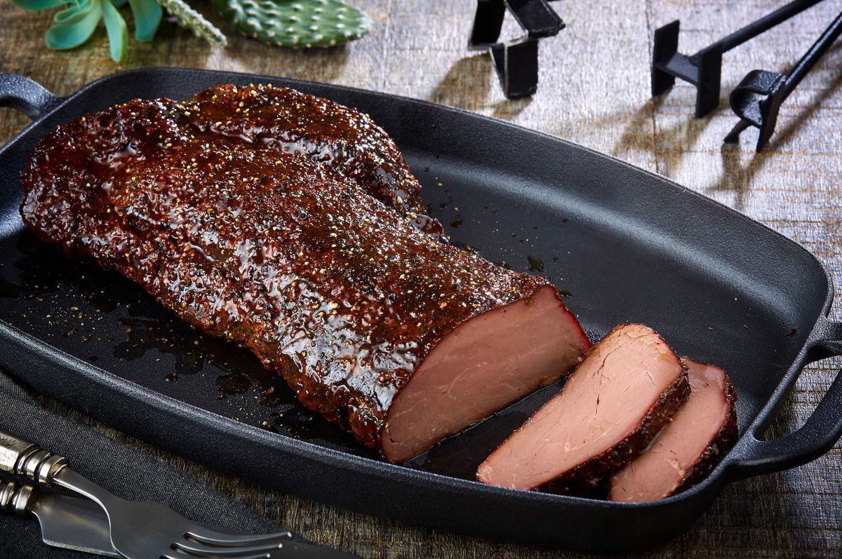 Ranch House mesquite smoked peppered beef sliced in a black cast iron serving dish