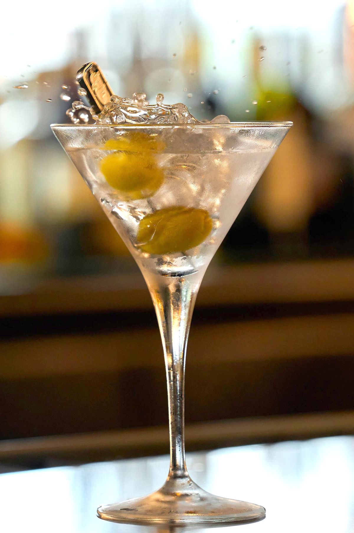 Luxury Steakhouse Martini with Olive Action Shot