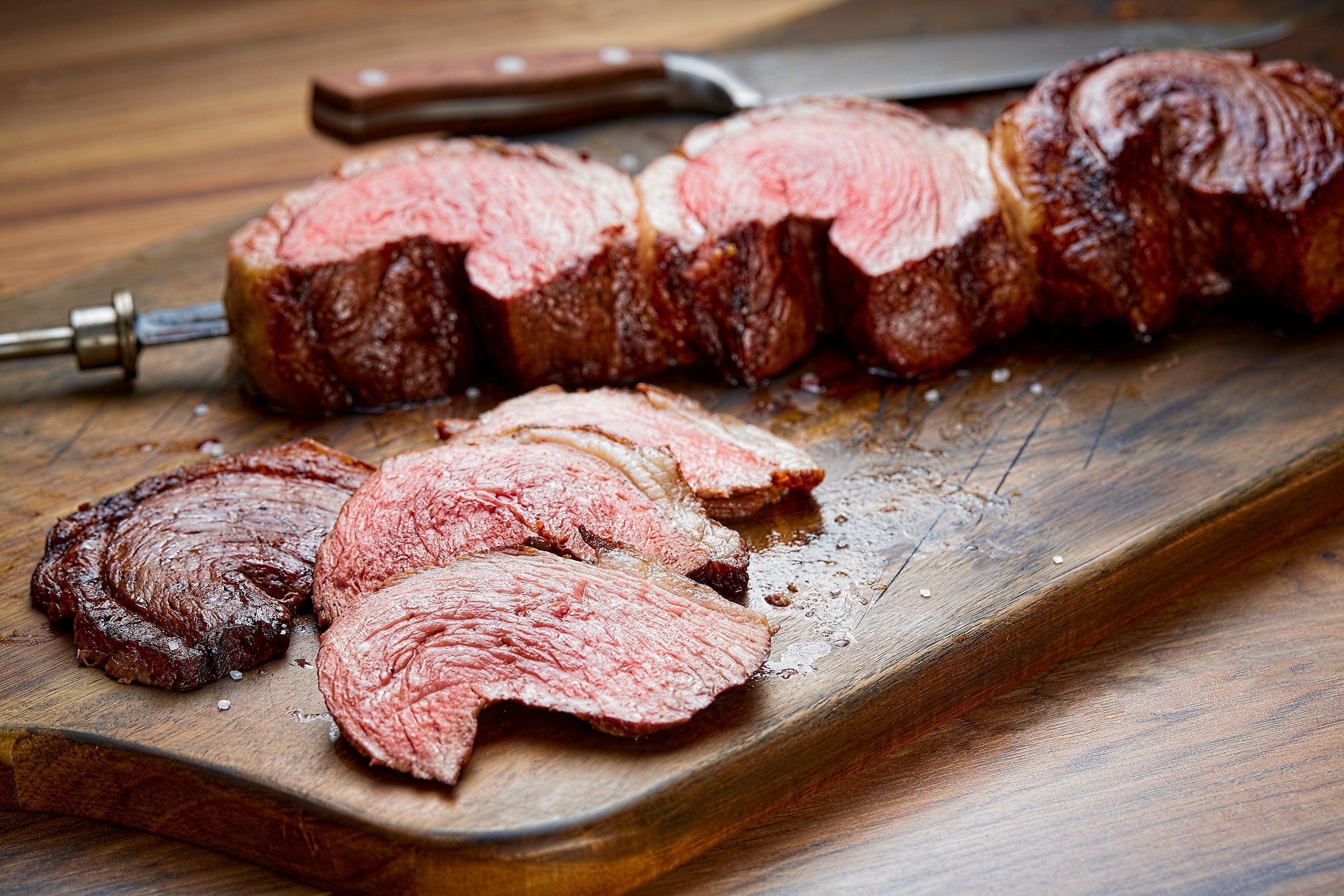 Fogo de Chão picanha carved from the churrasco skewer into crescent slices with sea salt