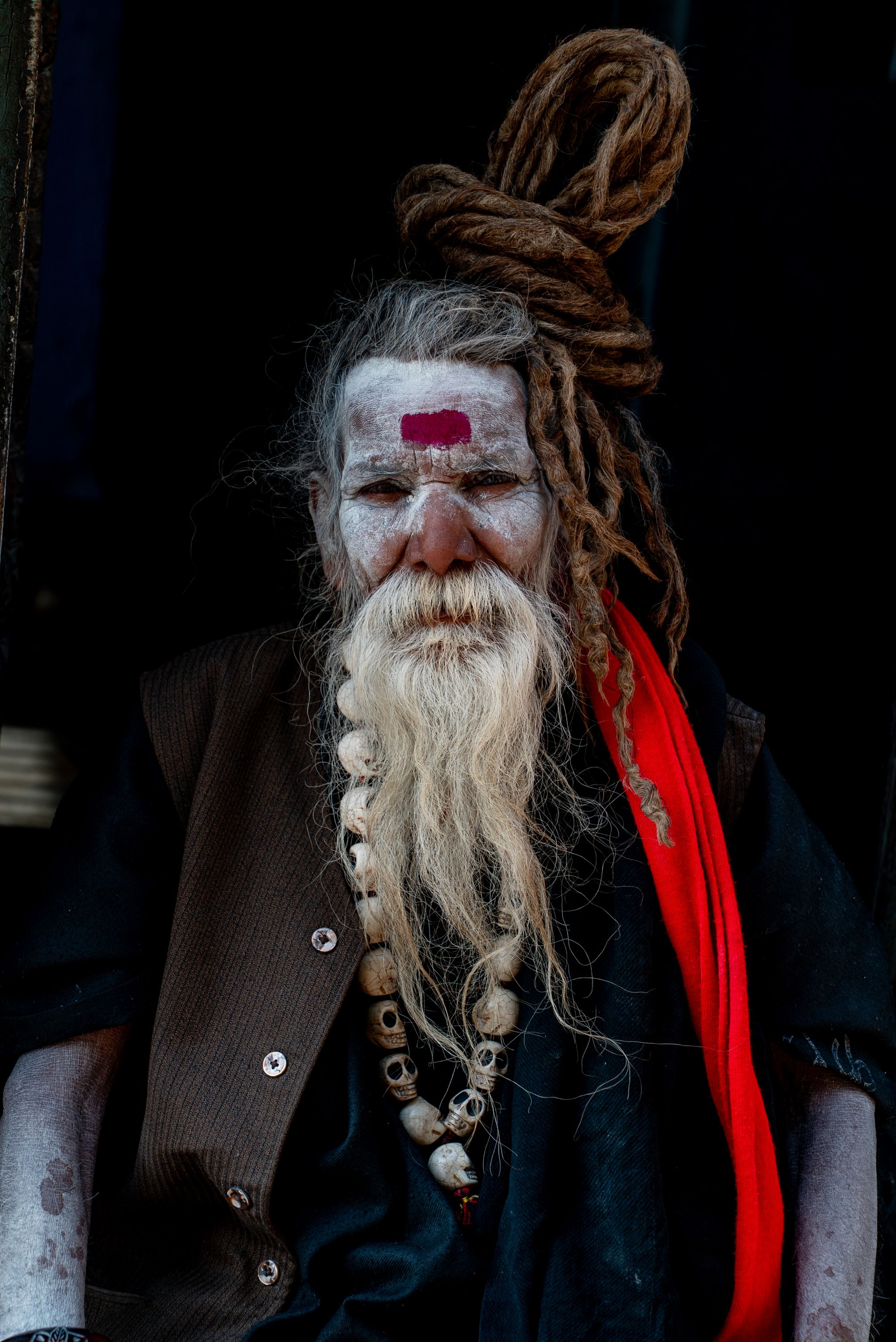 The Aghori (from Sanskrit: अघोर, lit. 'not dreadful', 'dreadless', IAST: aghora) are a Hindu monastic order of ascetic Shaivite sadhus based in Uttar Pradesh, India. They are the only surviving sect derived from the Kāpālika tradition, a Tantric, non-Puranic form of Shaivism which originated in Medieval India between the 4th and 8th century CE. Similarly to their Shaivite predecessors, Aghoris usually engage in post-mortem rituals, often dwell in charnel grounds, smear cremation ashes on their bodies,and use bones from human corpses for crafting kapāla (skull cups which Shiva and other Hindu deities are often iconically depicted holding or using) and jewellery. They also practice post-mortem cannibalism, eating flesh from foraged human corpses, including those taken from cremation ghats. Aghori
