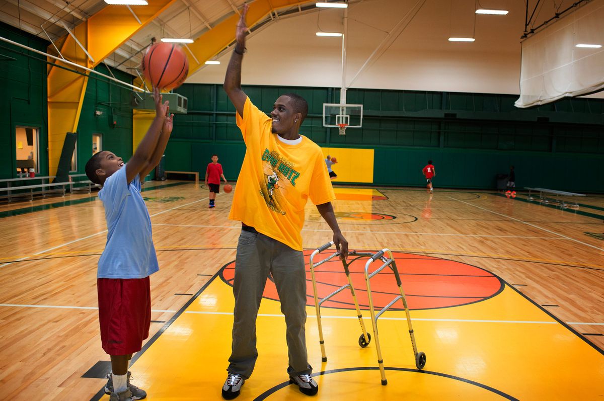 (right) Lamar Baker, 25, plays basketball with his son Khalil, 9, at Down Town Sports. Lamar's uncle Donald Osborne runs a basketball camp at the facility. Baker has multiple sclerosis. He is on disability and can not afford the cost of getting an ID card that would allow him to purchase marijuana legally. He uses marijuana to help with chronic pain. Llamar