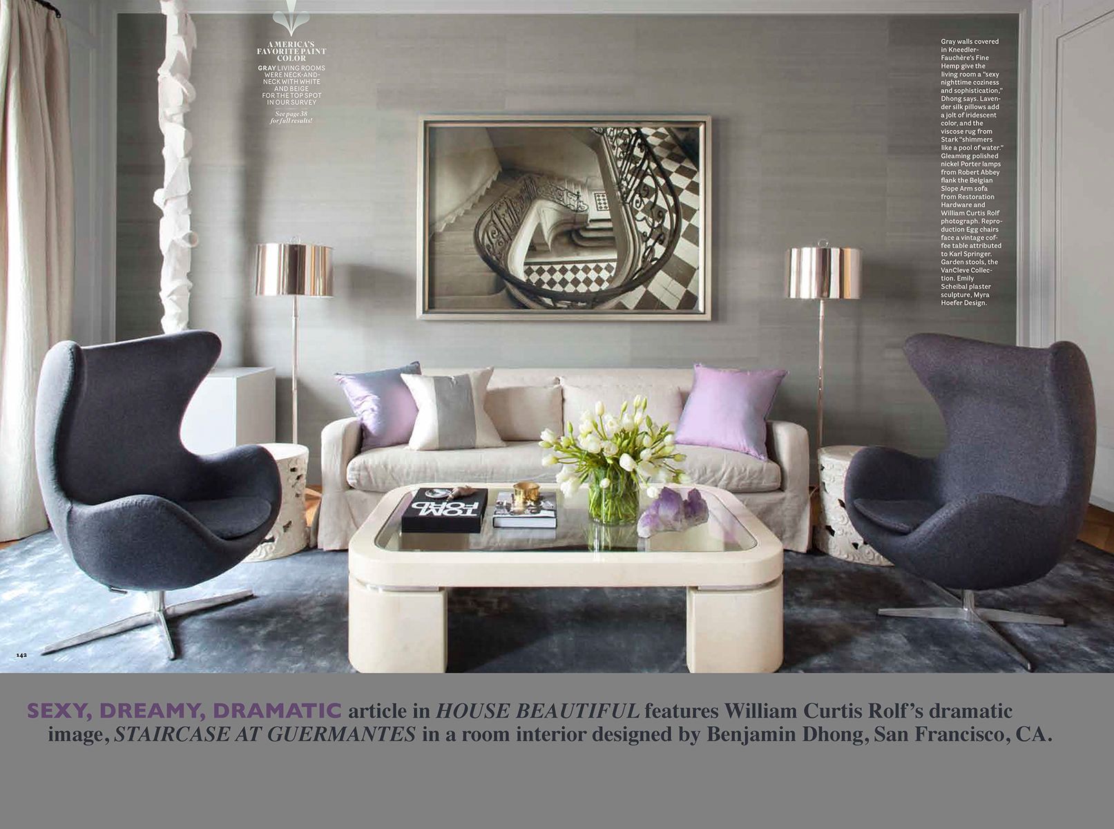 A page from House Beautiful showing a large black and white print of the Guermantes staircase downview installed on a wall in a luxury home. House Beautiful Editorial Feature Chateau de Guermantes Staircase In Situ