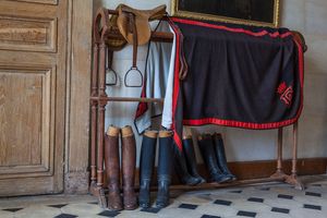 Horizontal color fine art photograph of traditional riding gear and a saddle inside private rooms at Château de la Ferté-Saint-Aubin by William Curtis Rolf. Château de la Ferté Saint Aubin Equestrian Interior Print
