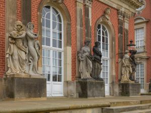 Color close up architectural photograph of the painted red brick facade and sandstone statues at the New Palace in Potsdam by William Curtis Rolf. Potsdam Germany New Palace Facade Close Up Color Print