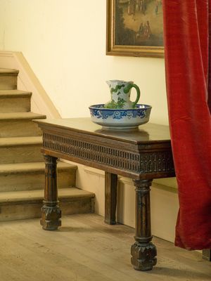 Inquire to acquire official limited edition color fine art prints of an atmospheric private corridor at Stanway House, England by William Curtis Rolf. William Curtis Rolf color photography Stanway House private corridor interior blue green porcelain crimson drape Gloucestershire England Noble Houses Portfolio