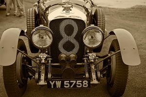 Fine-art sepia tone photograph by William Curtis Rolf capturing the front profile and original patina of the historic 1928 Bentley 4.5-Litre Le Mans Team Car at the Pebble Beach Concours d'Elegance. Pebble Beach 1928 Bentley 4.5 Litre Le Mans YW 5758 Sepia Print