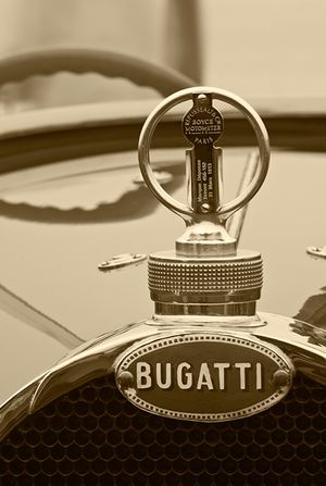 Fine-art sepia tone vertical photograph by William Curtis Rolf isolating a vintage Bugatti horseshoe radiator cap with a licensed Paris Repusseau Boyce MotoMeter temperature gauge. Pebble Beach Bugatti Boyce MotoMeter Radiator Fine Art Print