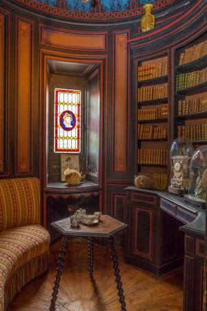 Color architectural photograph of a private circular turret library with curved wooden bookshelves at Château de la Bussière by William Curtis Rolf. Château de la Bussière Turret Library Fine Art Print