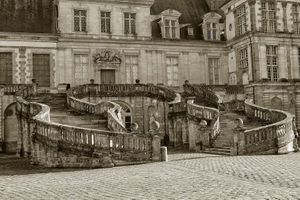 Black and white photograph of the historic Louis XIII double curved Horseshoe Staircase at the Palace of Fontainebleau by William Curtis Rolf. Château de Fontainebleau Horseshoe Staircase Fine Art Print