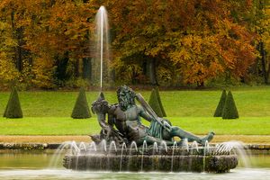 Color landscape photograph of a classical ornamental fountain surrounded by autumn trees at Chateau de Fontainebleau by William Curtis Rolf. Chateau de Fontainebleau Fountain Autumn Color Print