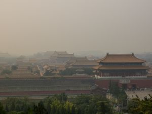 Color contemporary architectural photograph of the vast Forbidden City palace complex from an elevated hilltop view in Beijing by William Curtis Rolf. Forbidden City Beijing Hilltop Panoramic Color Print