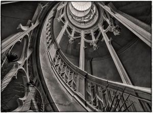 Black and white photograph of a Louis Visconti spiral staircase downview at Château de Challain-la-Potherie, France, by William Curtis Rolf. Château de Challain la Potherie Spiral Staircase Print