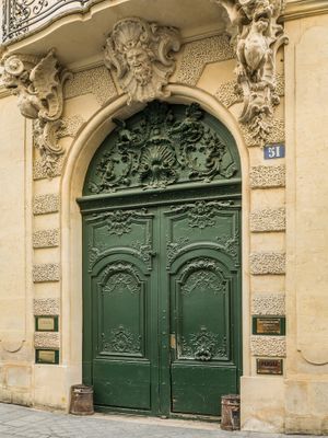Color architectural close up photograph of a striking forest green door and ornate 18th-century stone carvings at the historic Hôtel de Chenizot in Paris by William Curtis Rolf. Hotel de Chenizot Ile Saint Louis Paris Green Door Color Print William Curtis Rolf