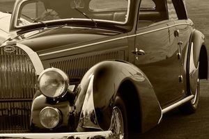 Fine-art sepia tone photograph by William Curtis Rolf capturing a left-rear side profile view emphasizing the elongated teardrop body shape of a vintage pre-war Bugatti. Pebble Beach Bugatti Teardrop Body Shape Sepia Print