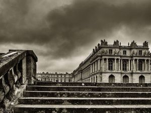 Sepia architectural photograph of the Hundred Steps Staircase with a dramatic cloudy sky at the Palace of Versailles by William Curtis Rolf. Versailles Escalier des Cent Marches Sepia Fine Art Print