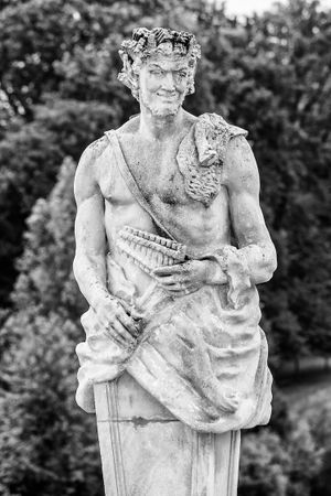 Black‑and‑white architectural study of a mythological statue in the classical French gardens of Château du Grand‑Lucé, France, photographed by William Curtis Rolf. Black‑and‑white photograph of a mythological statue in the classical French gardens of Château du Grand‑Lucé, France.