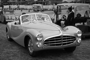 Fine-art black and white photograph by William Curtis Rolf capturing a side-angle profile of a light-colored vintage Italian two-seat convertible roadster at Pebble Beach. Pebble Beach Classic Italian Roadster Fine Art Black and White Print