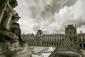 Inquire to acquire official limited edition black and white fine art prints of a dramatic aerial Louvre courtyard view by William Curtis Rolf, from the Objects & Architectural Details collection. William Curtis Rolf black and white photography Louvre pyramid statue aerial view dramatic sky courtyard Paris France Architectural Details Portfolio