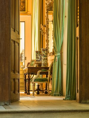 Inquire to acquire official limited edition color fine art prints of a private historic room at Stanway House, England by William Curtis Rolf, from the Houses of French & English Nobility collection. William Curtis Rolf color photography Stanway House private interior green silk drapes mirror antique furniture Gloucestershire England Noble Houses Portfolio