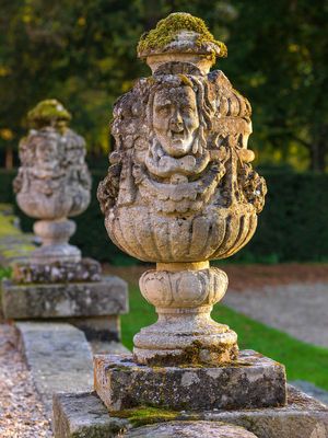 Color photograph of a classical stone urn on the geometric parterre gardens at Chateau de Fleury-en-Biere in France by William Curtis Rolf. Chateau de Fleury en Biere Garden Urn Color Print