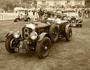 Fine-art sepia tone photograph by William Curtis Rolf capturing a front view of the historic 1930 Bentley 4.5-Litre Supercharged Blower Le Mans Tourer marked with competition number 8 at the Pebble Beach Concours d'Elegance. Pebble Beach Bentley Blower 4.5 Litre Competition Number 8 Sepia Print