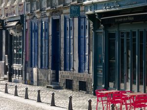 Color photograph of vibrant historic buildings and colorful restaurant chairs on Rue de Gand in Lille by William Curtis Rolf. Lille France Rue de Gand Architecture Food Curiosities Color Print
