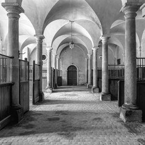 Fine art photograph of the historic 19th-century stables and tack room at Château de Chaumont in France, captured in black and white by William Curtis Rolf. Equestrian Fine Art Print: Château de Chaumont Stables by William Curtis Rolf
