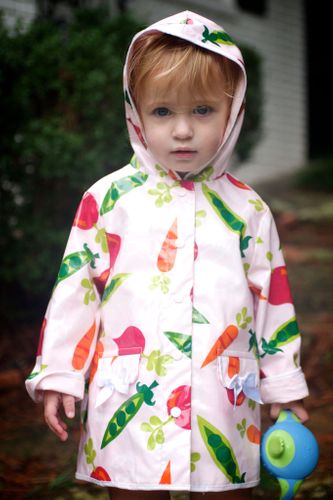 Little girl in a raincoat on a spring morning family portrait