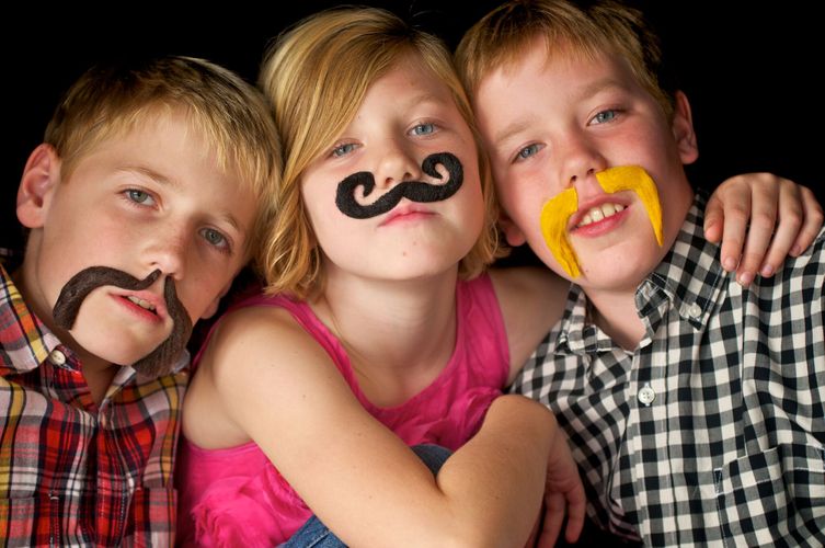Siblings wearing fake mustaches siblings
