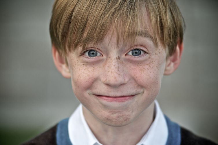 Young man and his blue eyes smiling for the camera, family portrait Atlanta GA kid portrait
