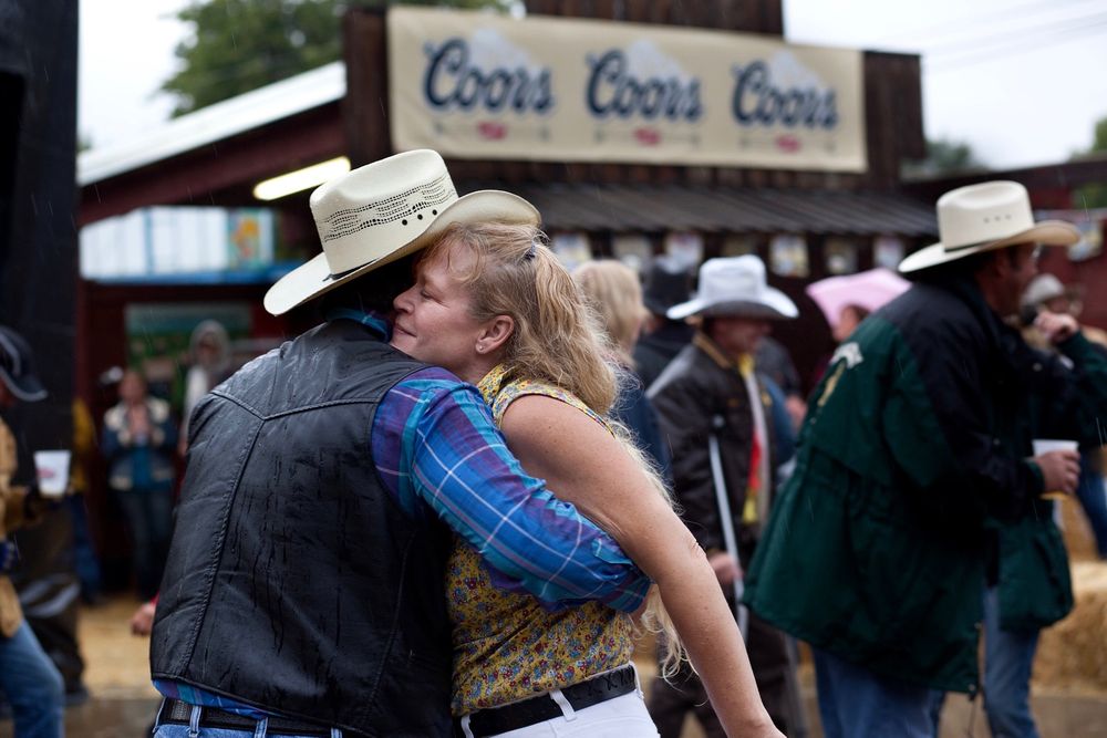 a couple dancing close together at the ellensberg rodeo with coors sign in background Ellensberg Rodeo