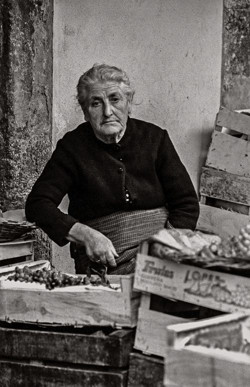 Elderly woman at market  in Santiago, Spain 1974 Photograph by Nancy LeVine
