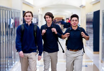 Students walking down hall in high school 