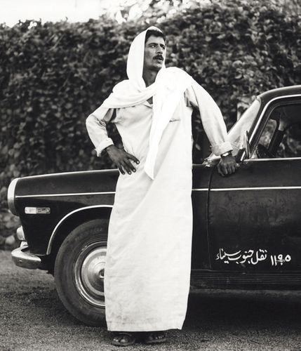Blind Man standing beside Car. Dahab, Egypt