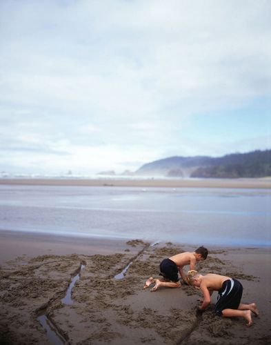 Boys playing in sand on Canon Beach, Oregon