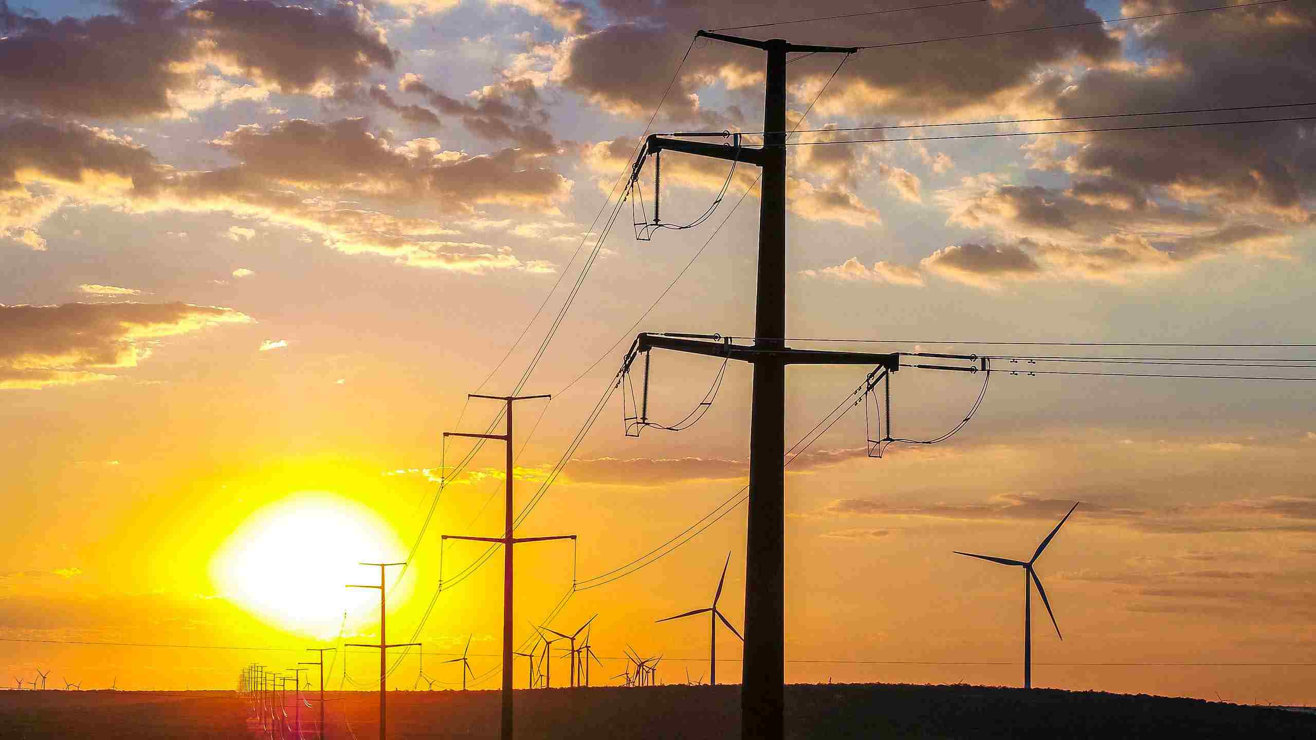 Aerial drone photo of a power grid at sunset, highlighting energy infrastructure and the beauty of industrial landscapes. Drone Aerial of Power Grid at Sunset - Industrial Photography