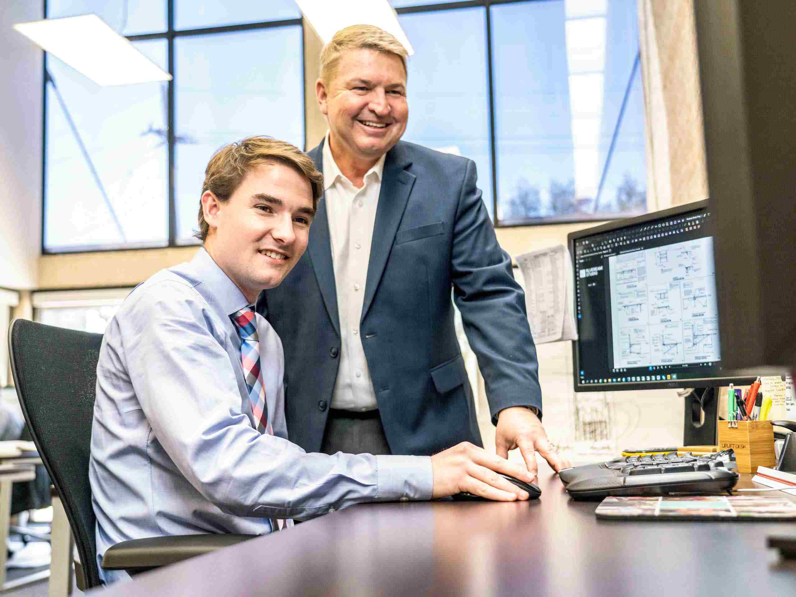 Corporate photo of an architect designing in their workplace, showcasing professional dedication and creativity. Architect Designing in Workplace - Dallas Corporate Photography
