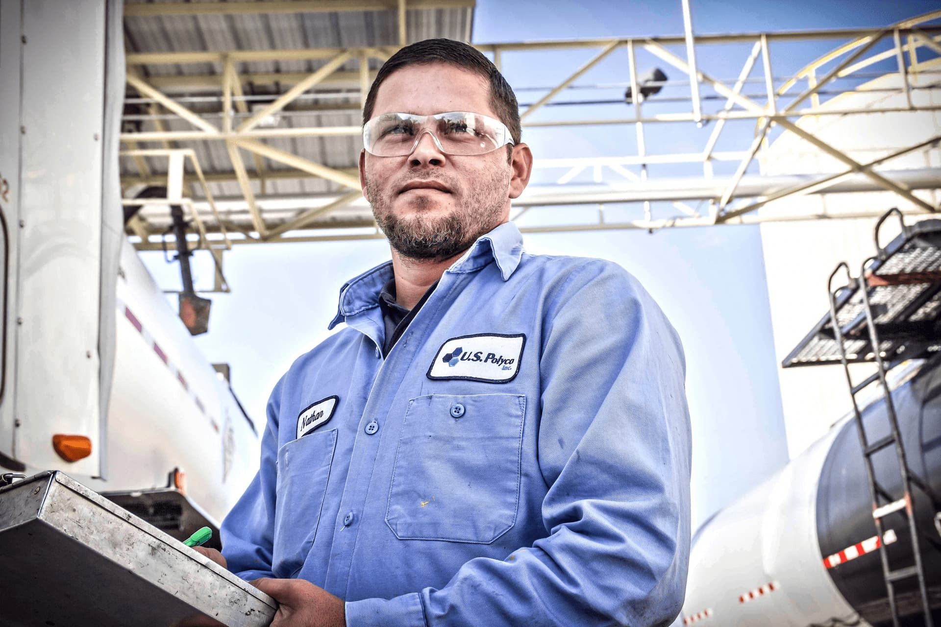 Industrial photo of an asphalt plant employee at work, highlighting infrastructure maintenance and professional dedication in Dallas. Asphalt Plant Employee Working - Dallas Industrial Photography
