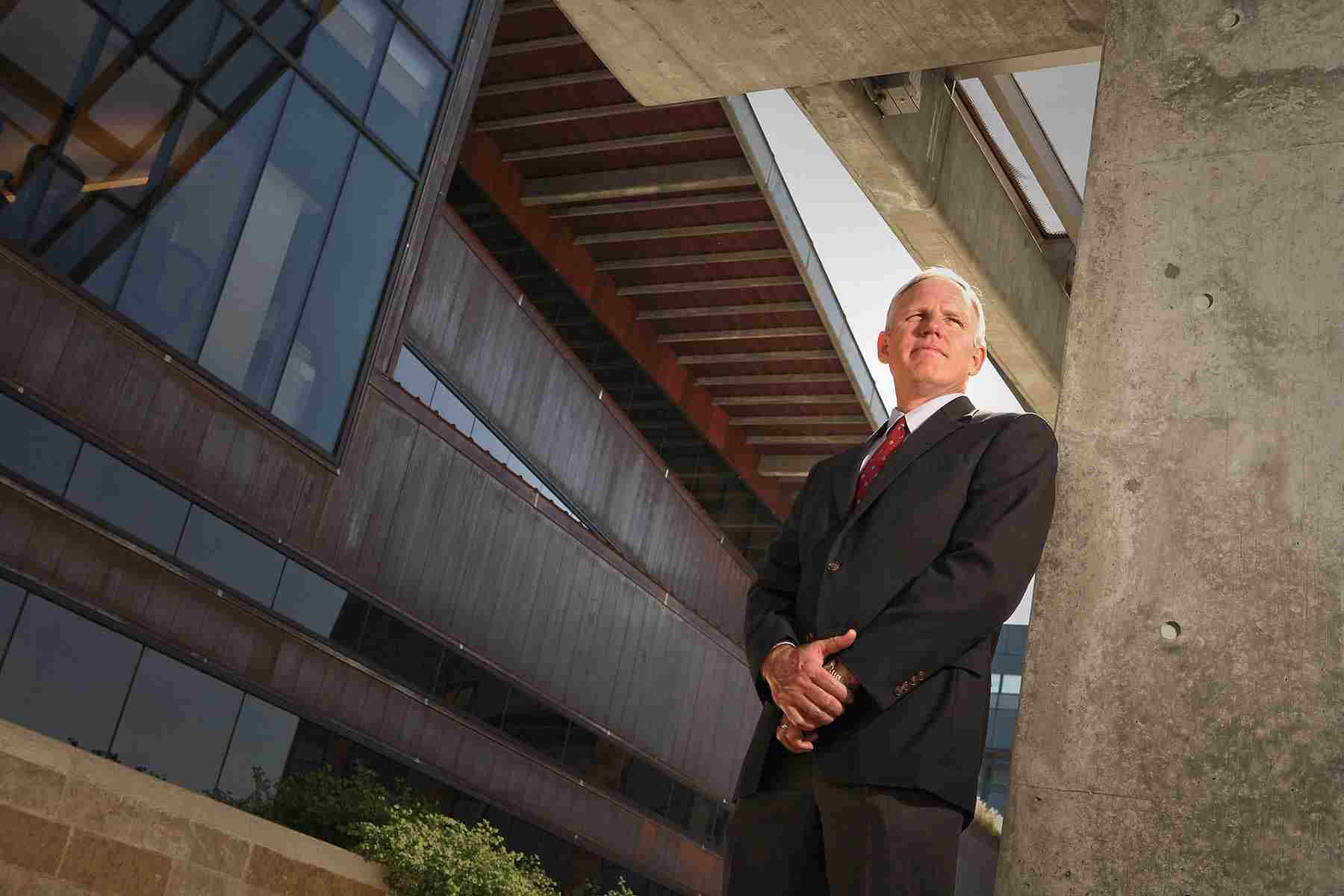 Business portrait of an architect at his designed building, emphasizing professional achievement and architectural vision. Architect Portrait at Designed Building - Dallas Professional Photography