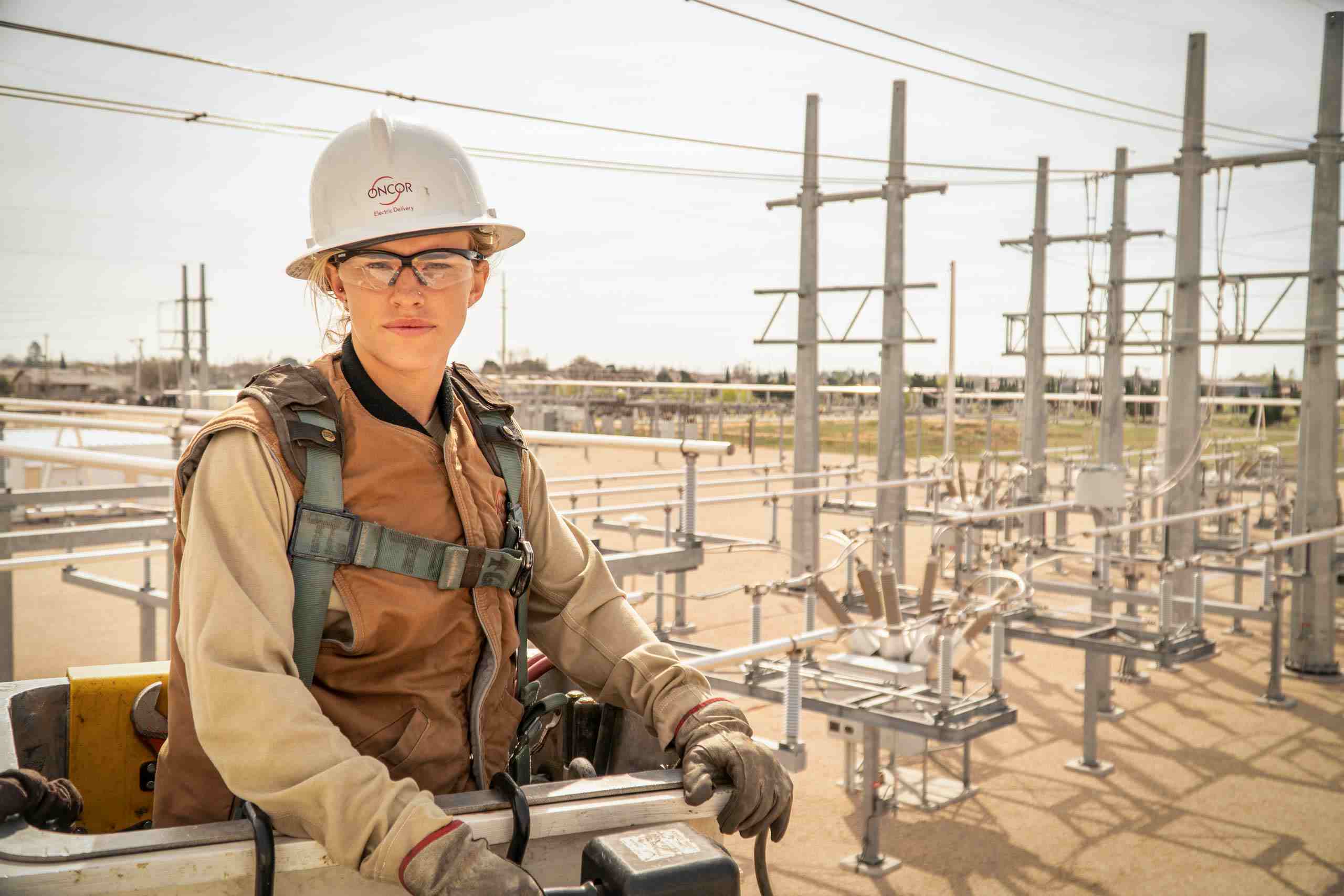 Pioneering Spirit: Powerful Portrait of Female Oncor Employee with Grid in the Background