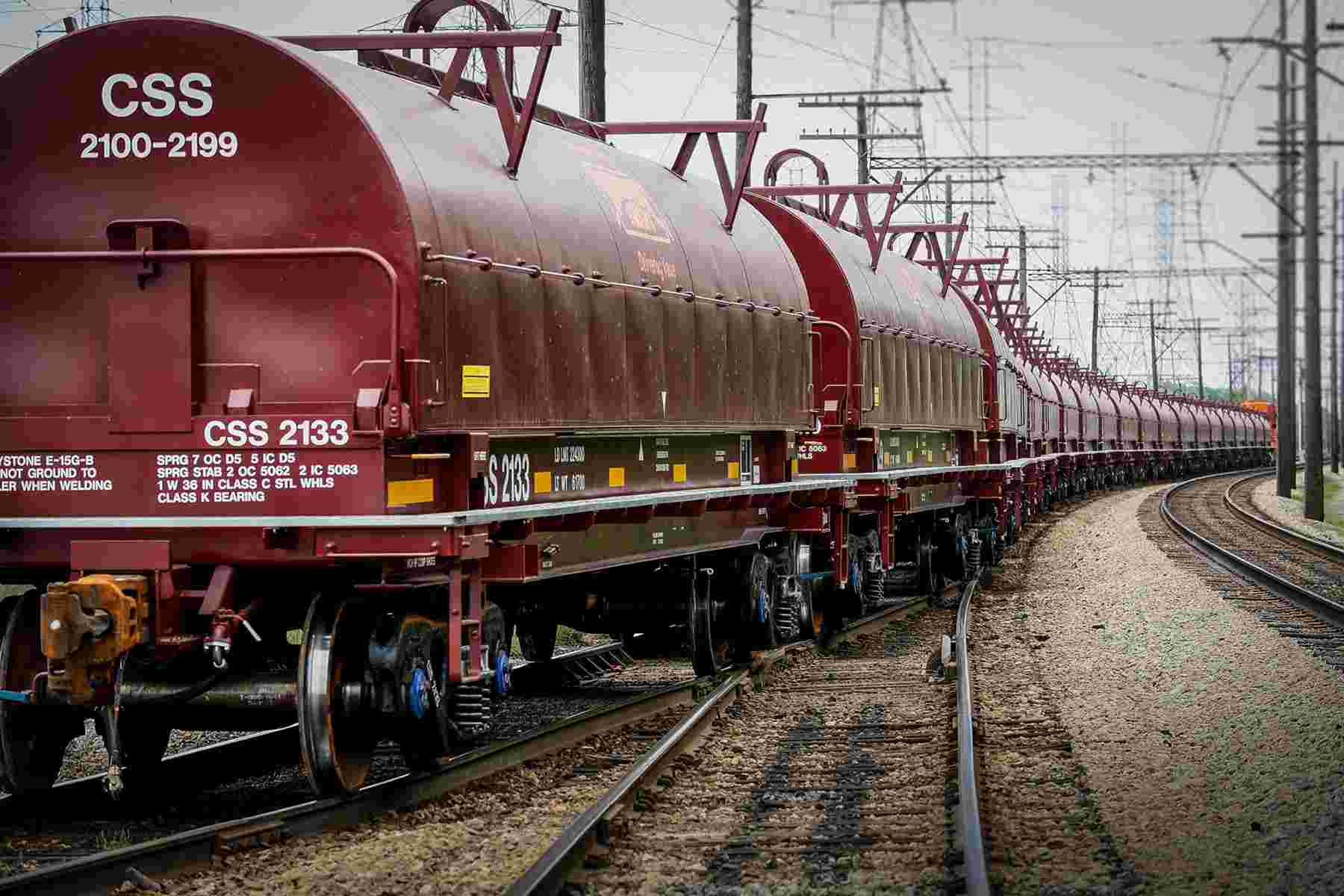 Long line of coil cars on tracks.