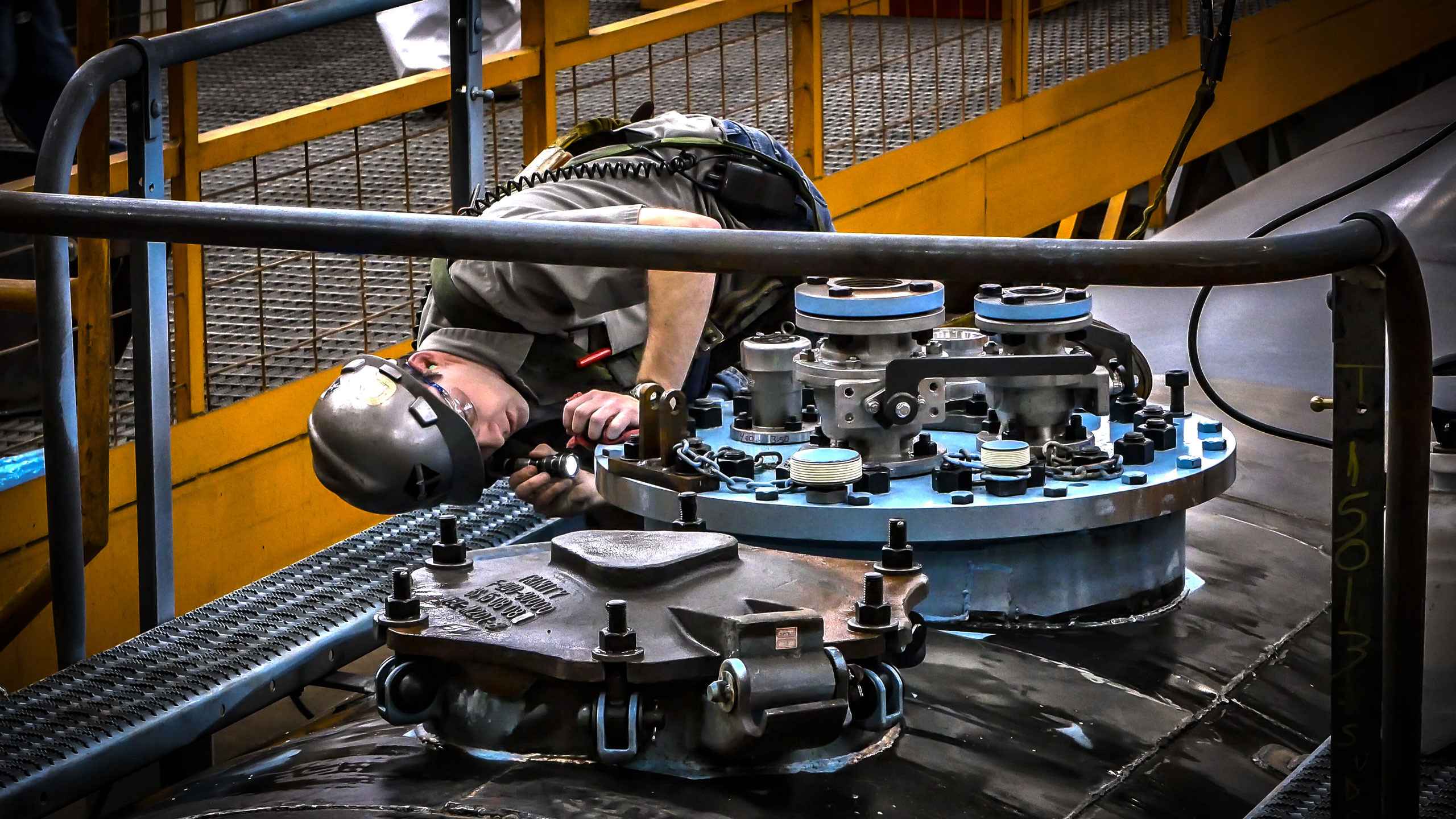 Industrial photo of a pressure tank can top fitting inspection, highlighting quality control in manufacturing. Pressure Tank Can Top Fitting Inspection