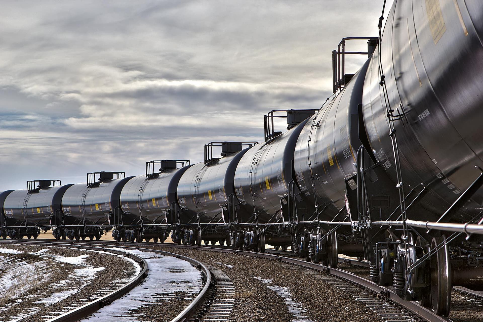 An industrial photo capturing a line of tank cars being loaded at a facility in South Dakota, highlighting the efficiency and scale of industrial logistics. Captured by C Ray Pictures, expert industrial photographers serving clients nationwide. Tank Cars Loading at Facility - Industrial Photography in South Dakota