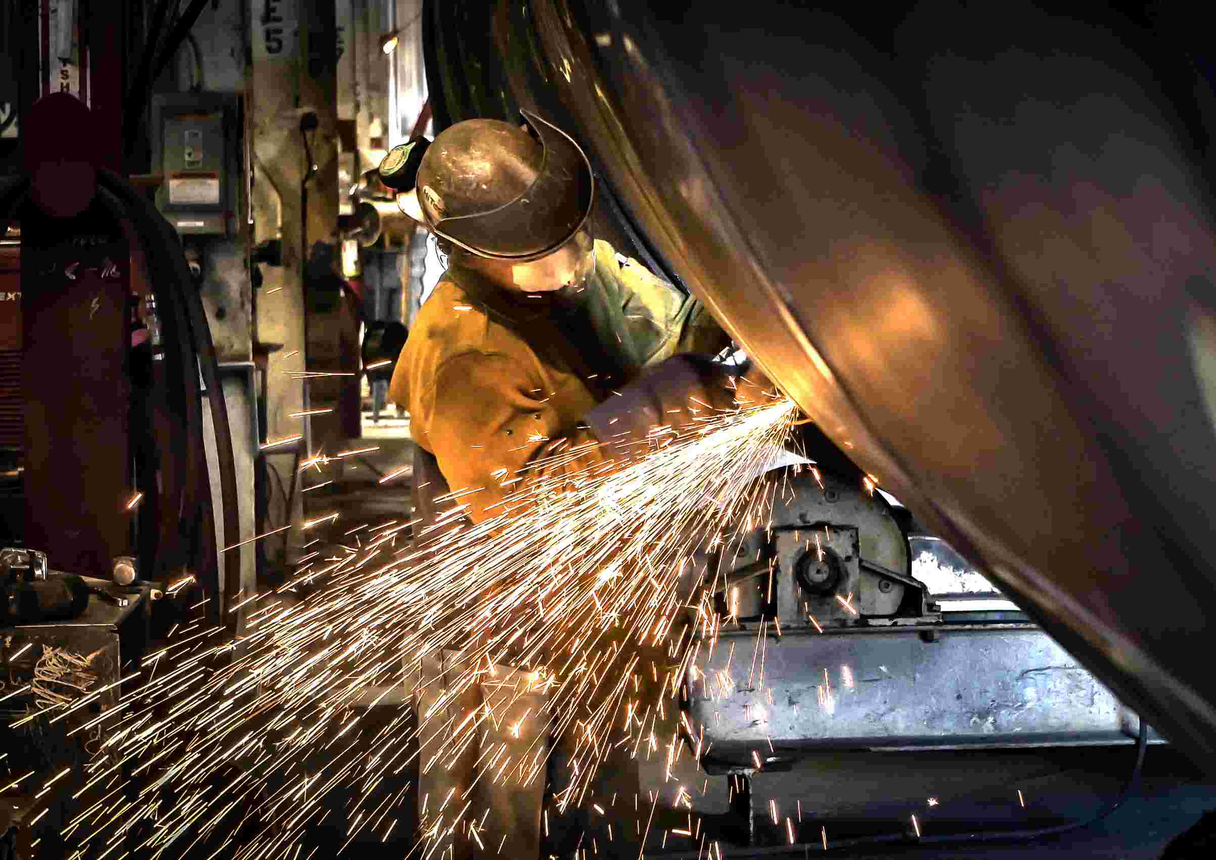 Metal Grinder Operator with Sparks Flying