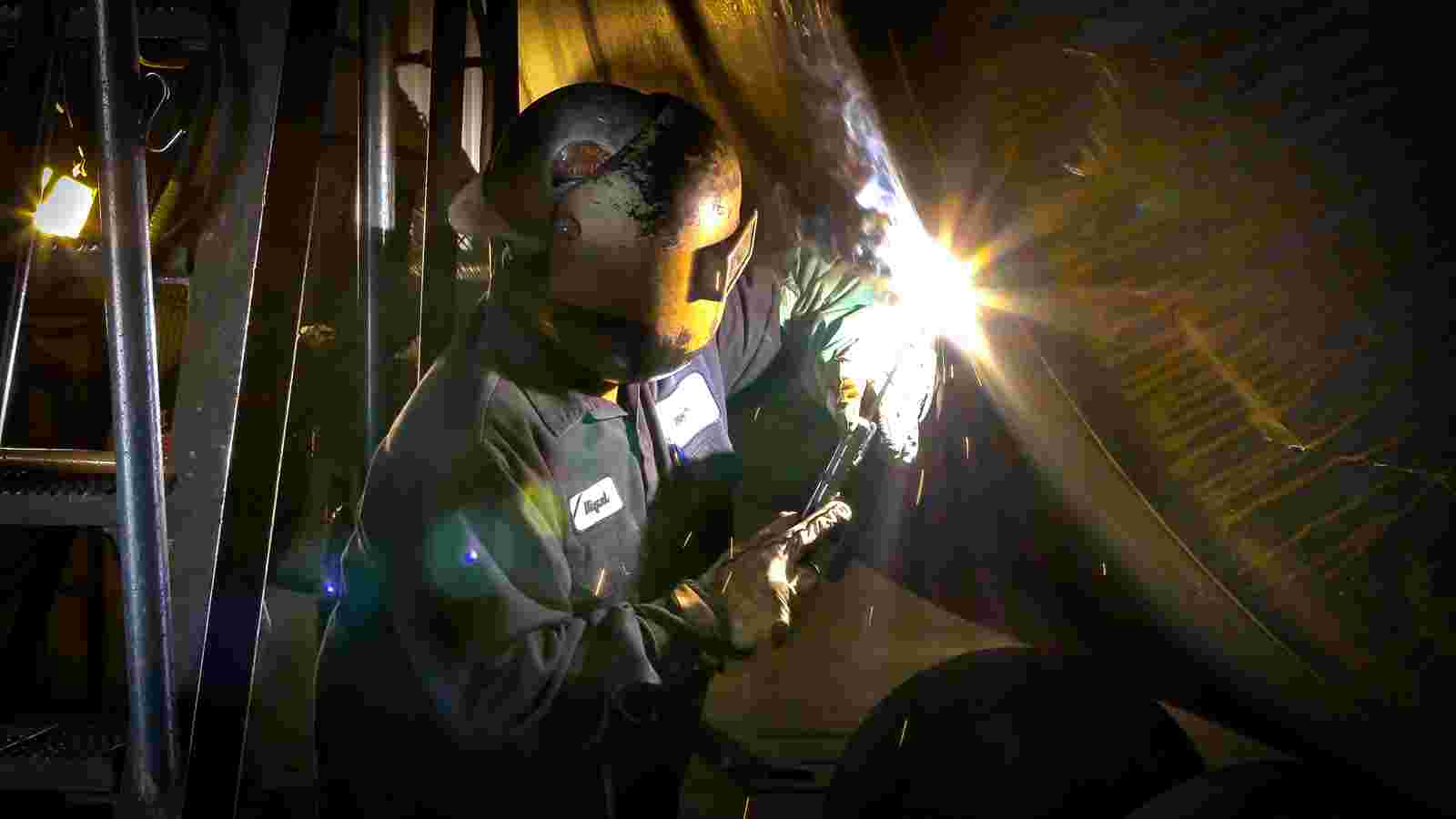 Wielder at work building tank cars.