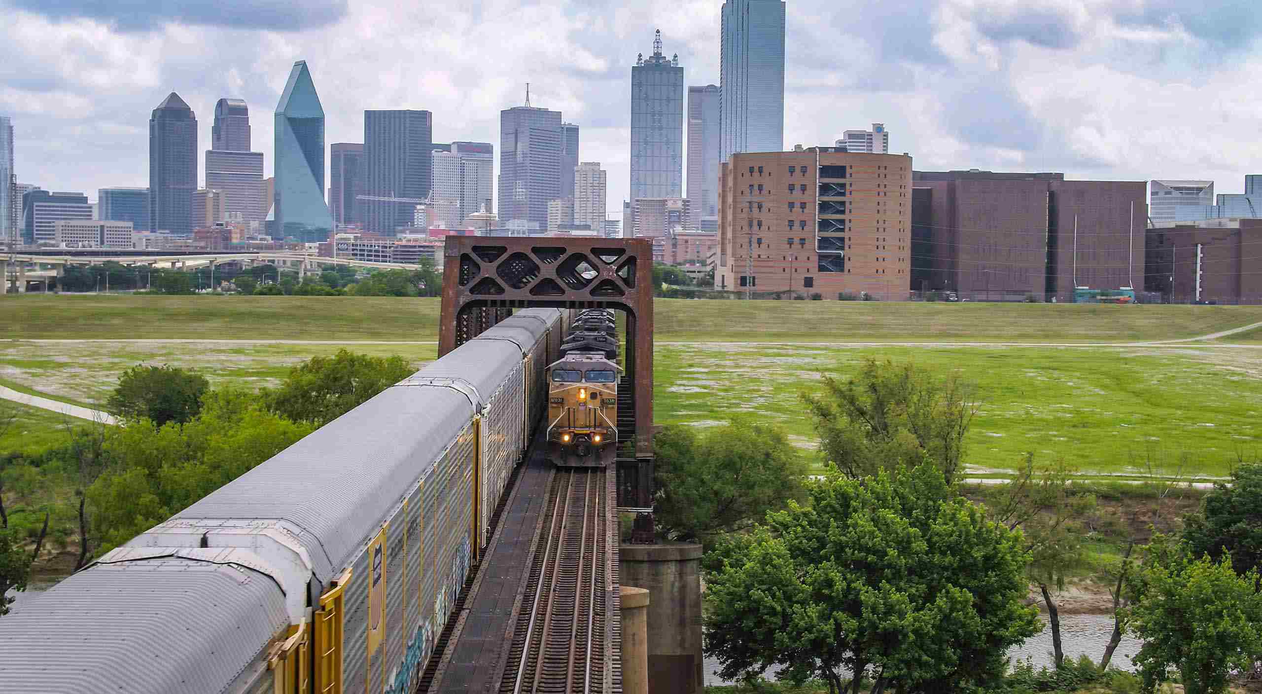 Aerial photo of AutoRack cars in service, captured using commercial drone photography, highlighting rail transport operations. Drone Photography of AutoRack Cars in Service - Industrial Imagery