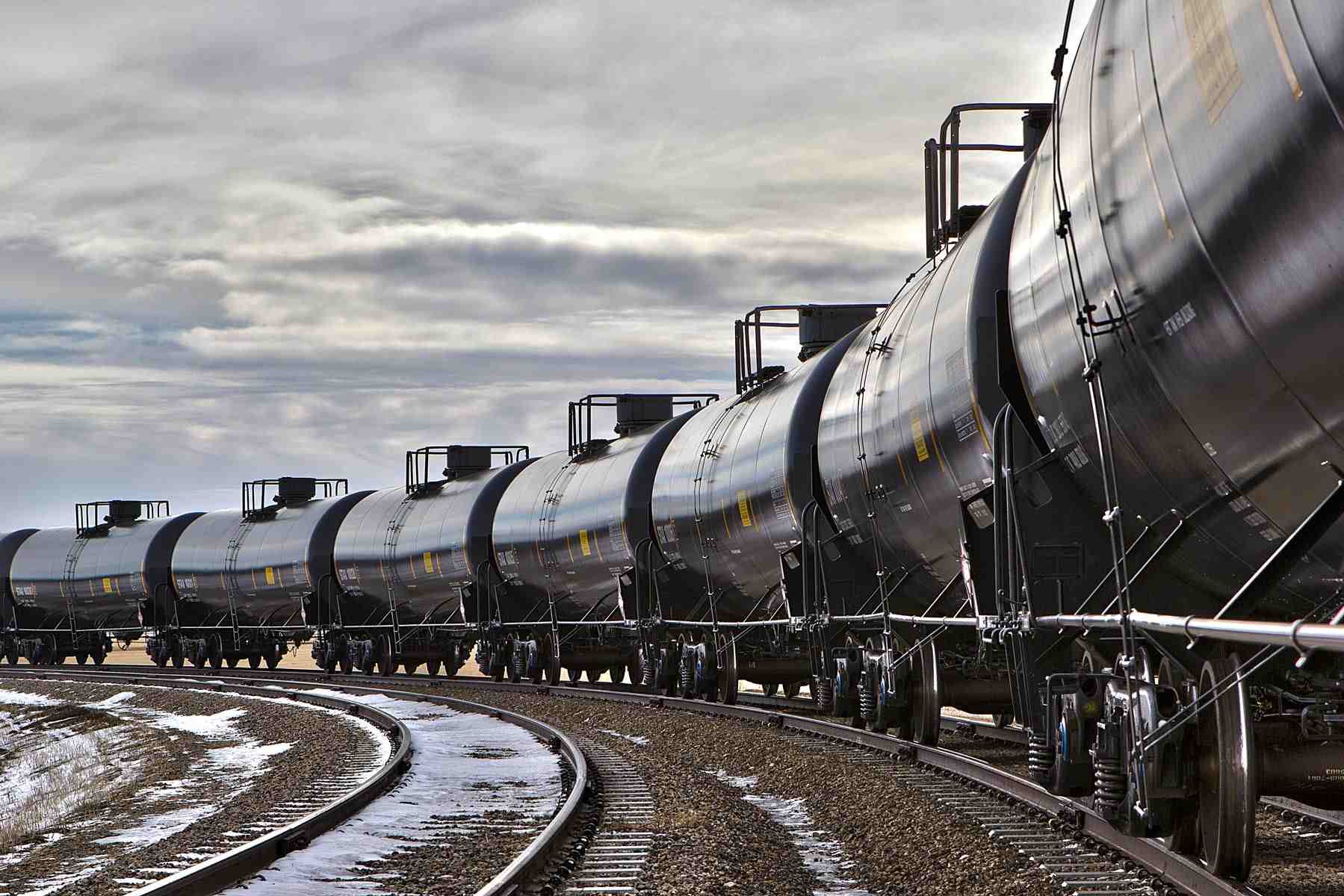 Snow-Covered Tranquility: Tank Cars Await Crude Oil Loading in Winter Scene