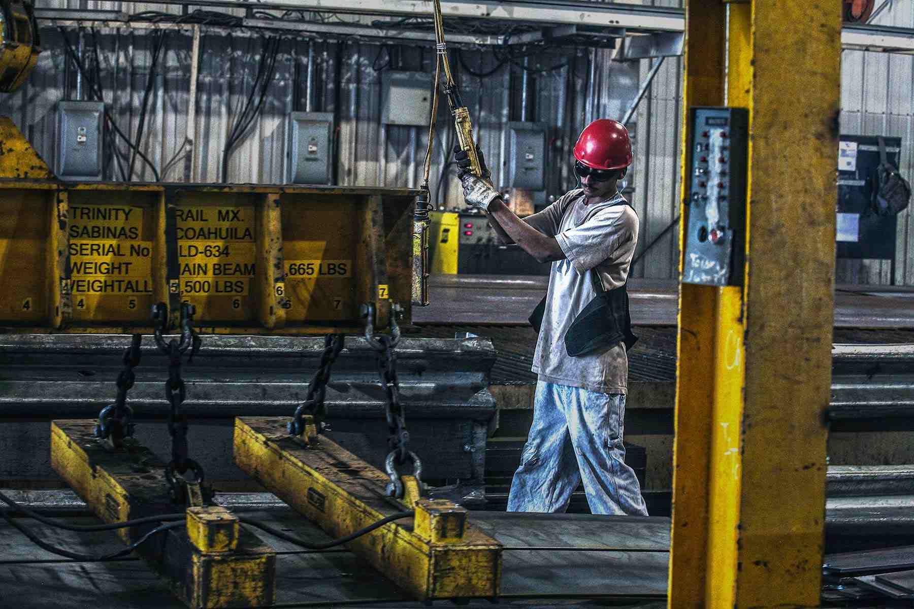 Effortless Power: Factory Worker Operating Heavy Lifting Equipment