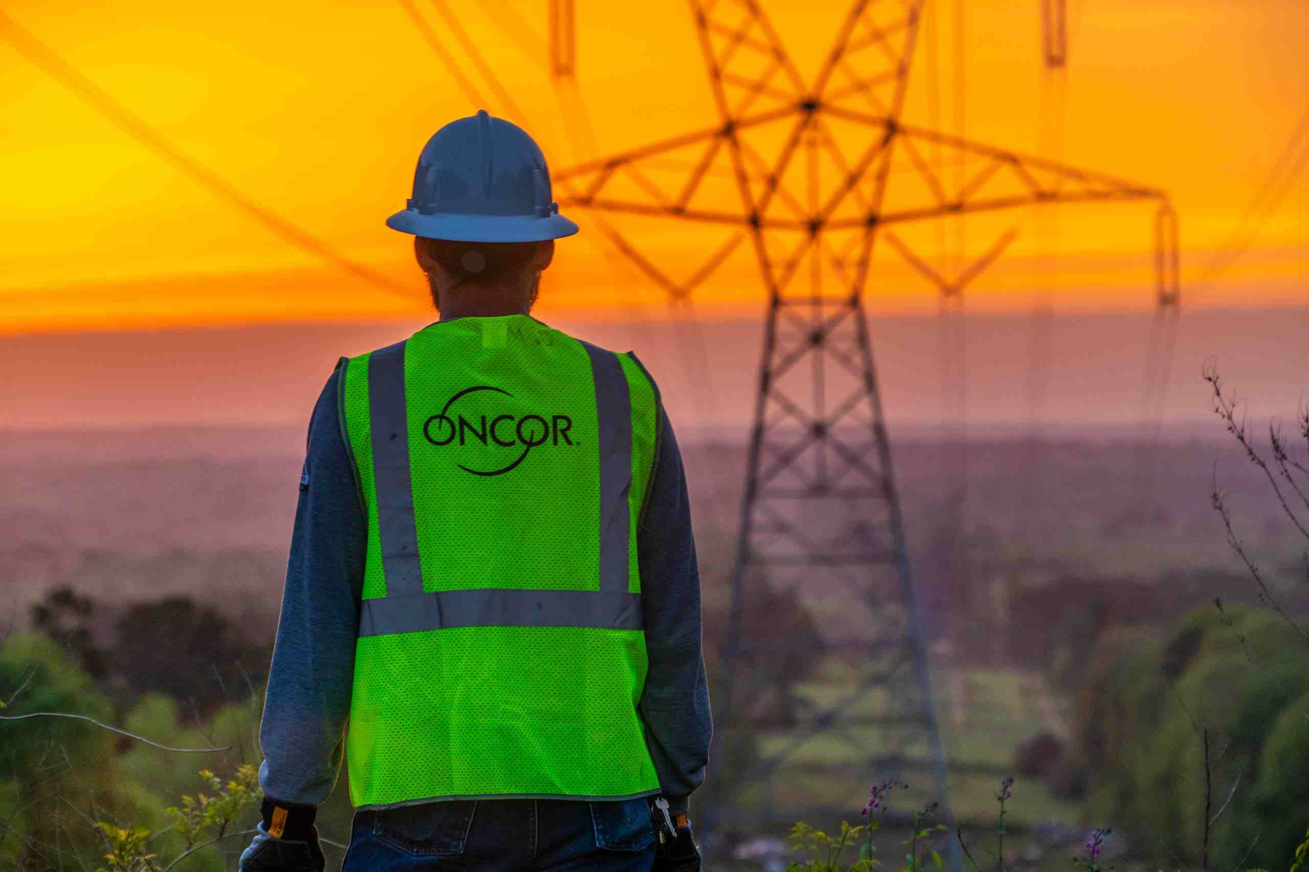 At sunrise Oncor lineman inspecting energy infrastucture 