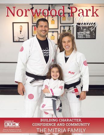 Portrait of the Mitria family wearing martial arts attire inside a Brazilian jiu-jitsu gym. Mitria Family